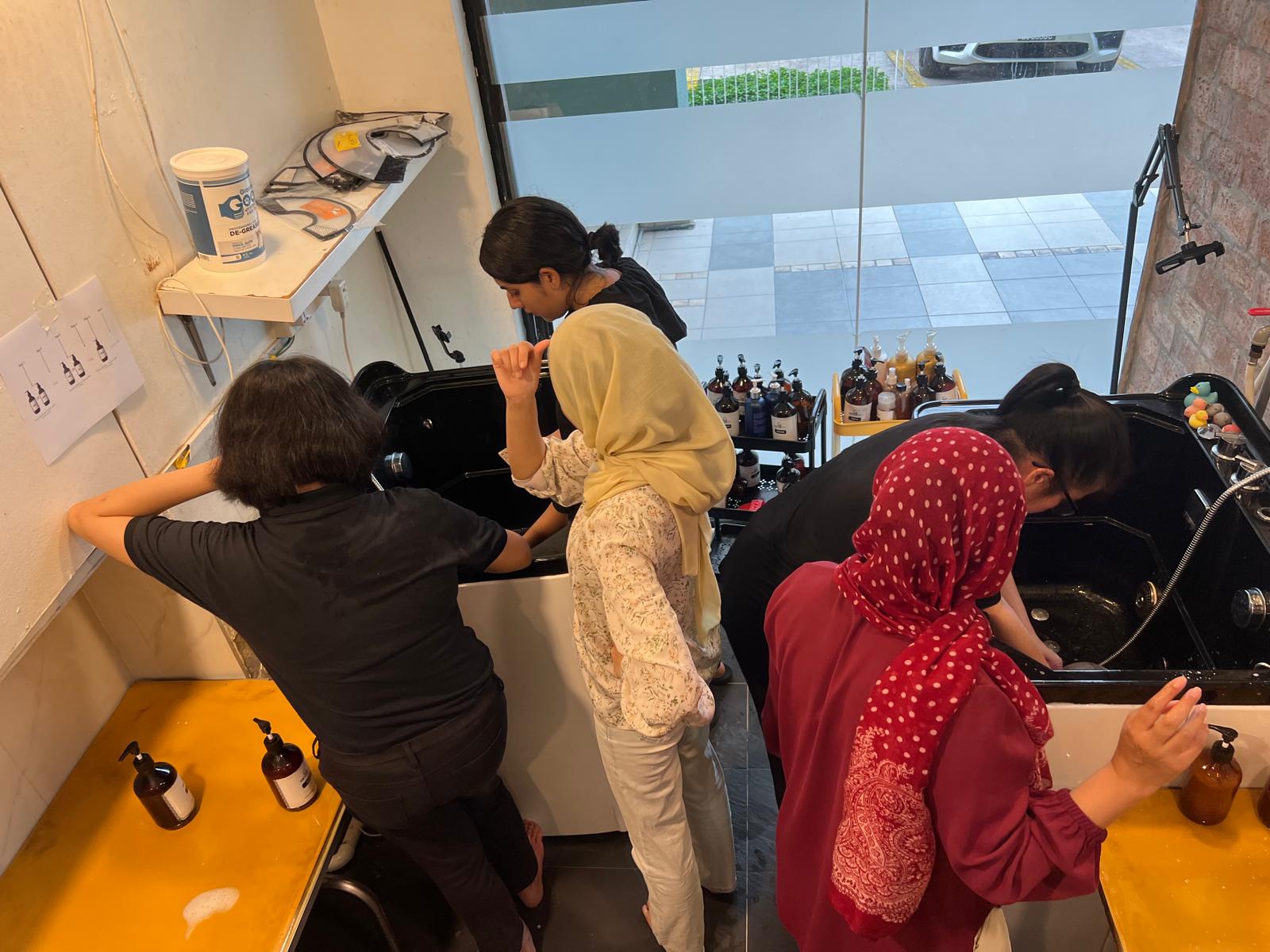 Trainees practising the bathing routine at the grooming stations