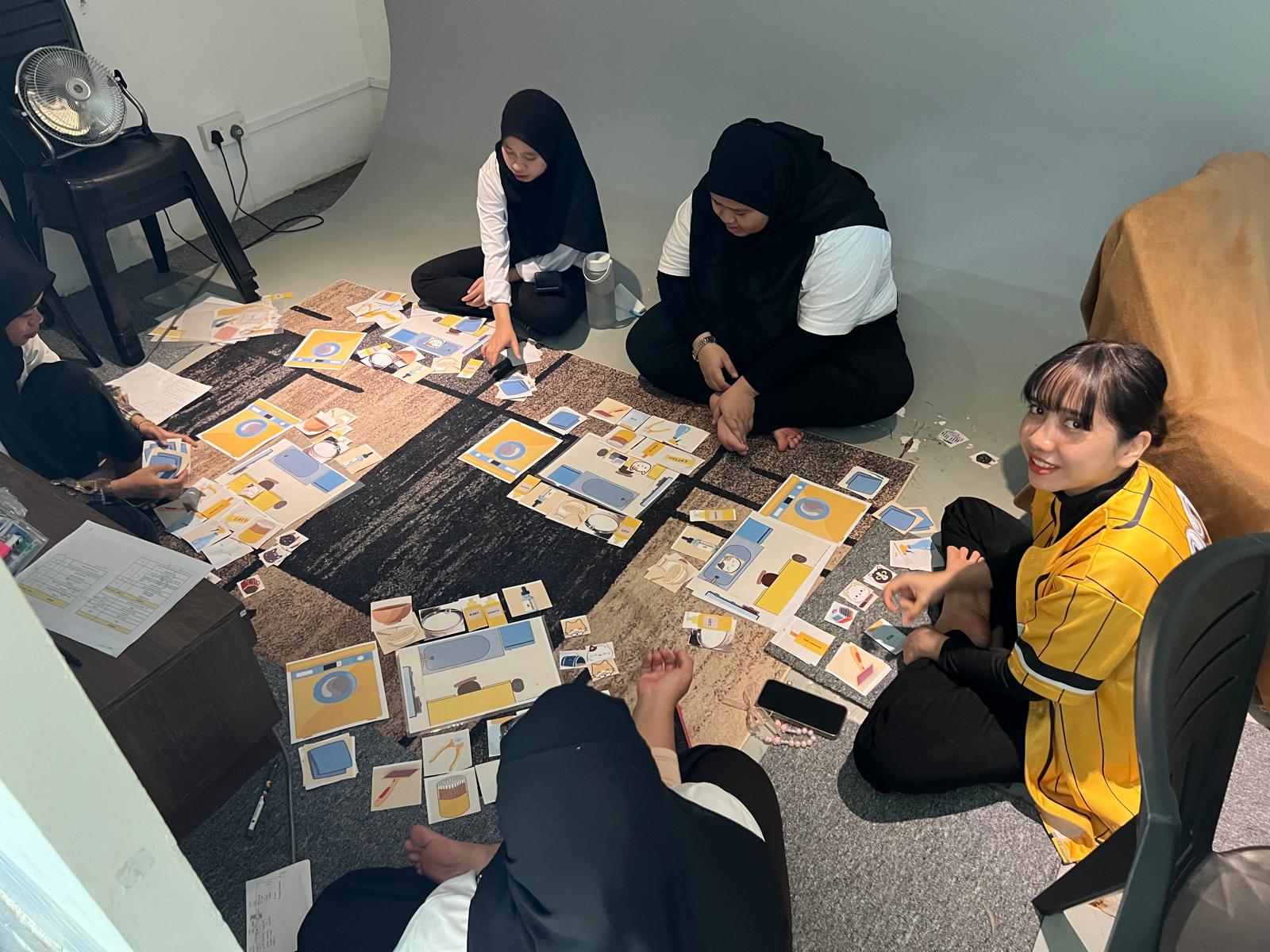 Trainees doing a hands-on grooming card-sorting exercise on the floor